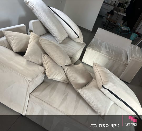 ספות וכריות לאחר ניקוי, מסודרות בחדר מגורים